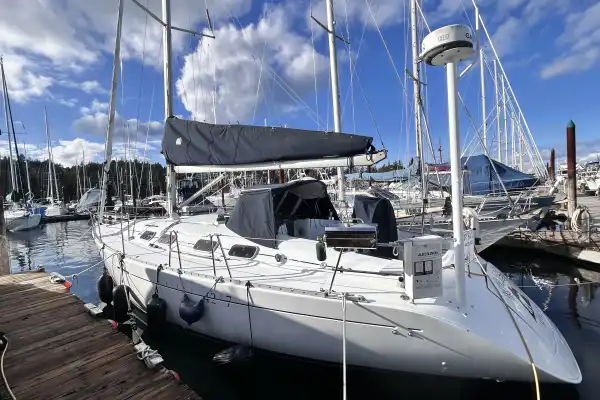 Beneteau 42s7 Sailboat Port Aft Quarter With Radar, BBQ, Navy Blue Dodger Cover and Navy Blue Doyle Stack Pack For The Mainsail